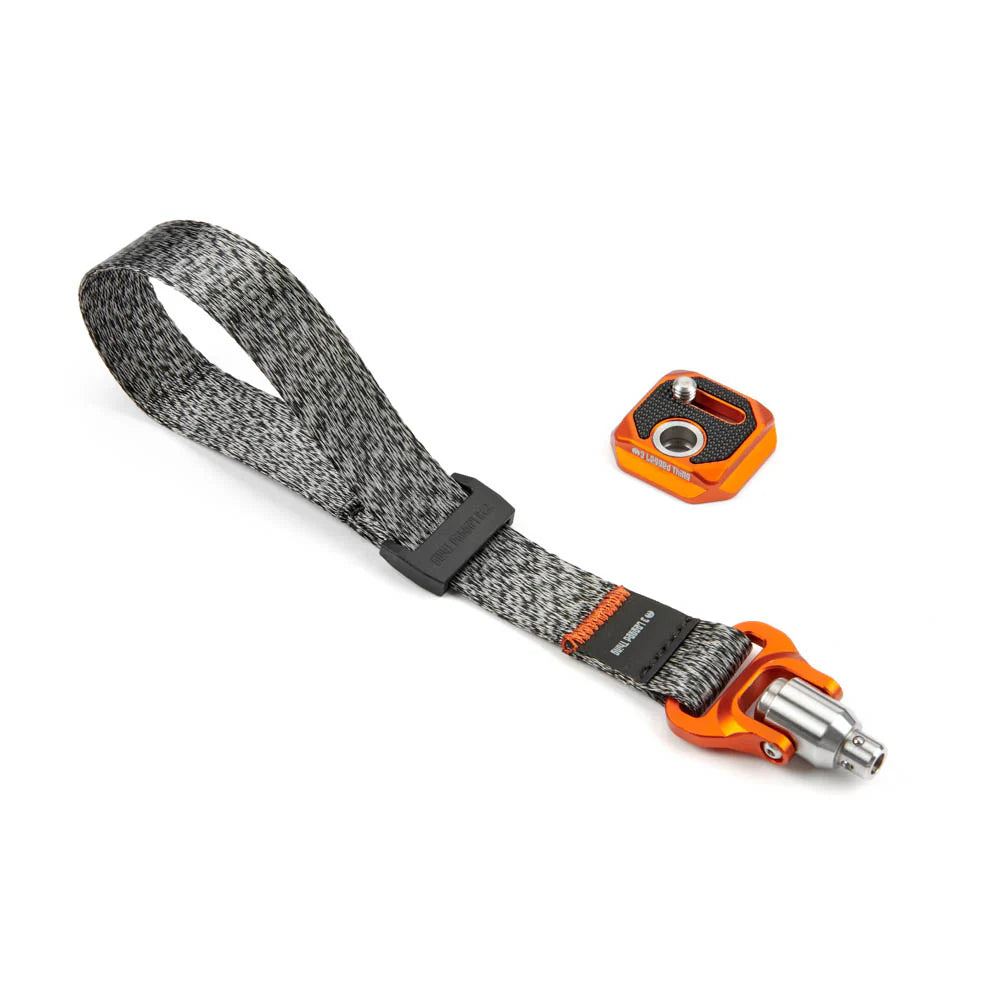 Gray woven wrist strap with orange and black metal connectors on a white background