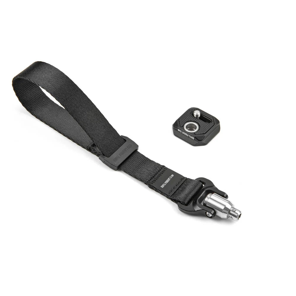 Black camera strap with quick-release plate on a white background