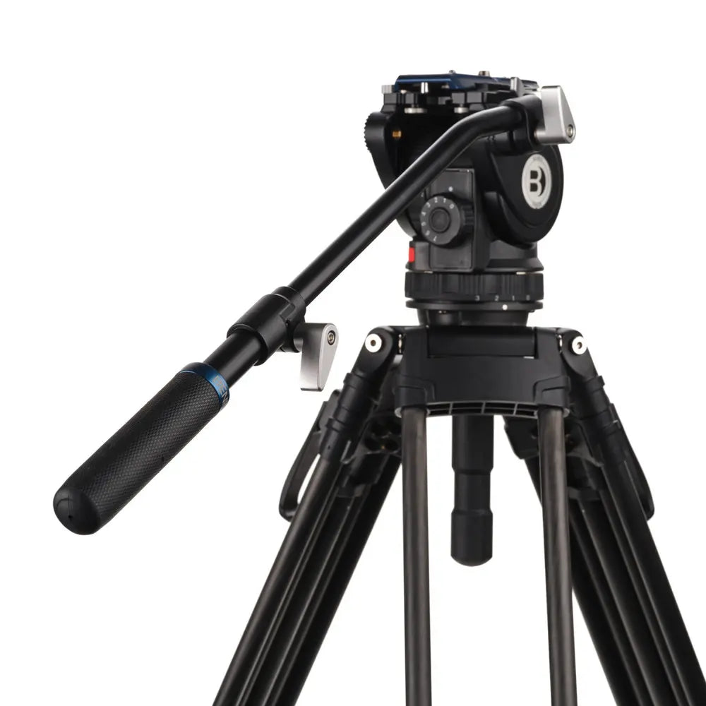 Black camera tripod with head on a white background