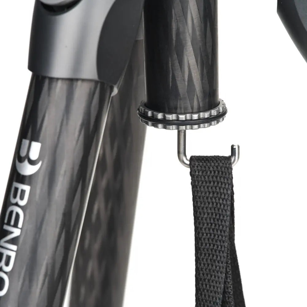 Close-up of a Benro tripod with a strap on a white background