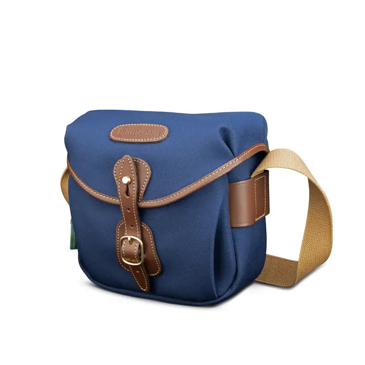 Blue bag with brown leather straps on a white background