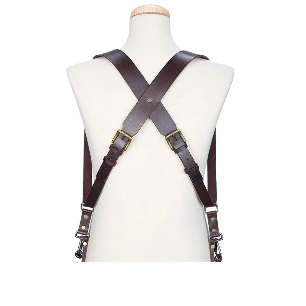 Brown leather suspenders on a mannequin with a white background