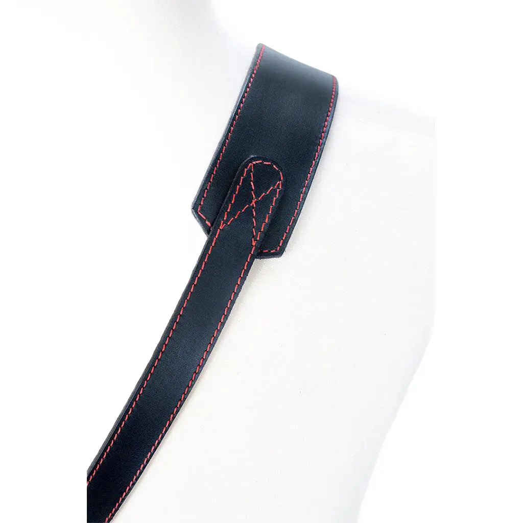 Black leather strap with red stitching on a white background