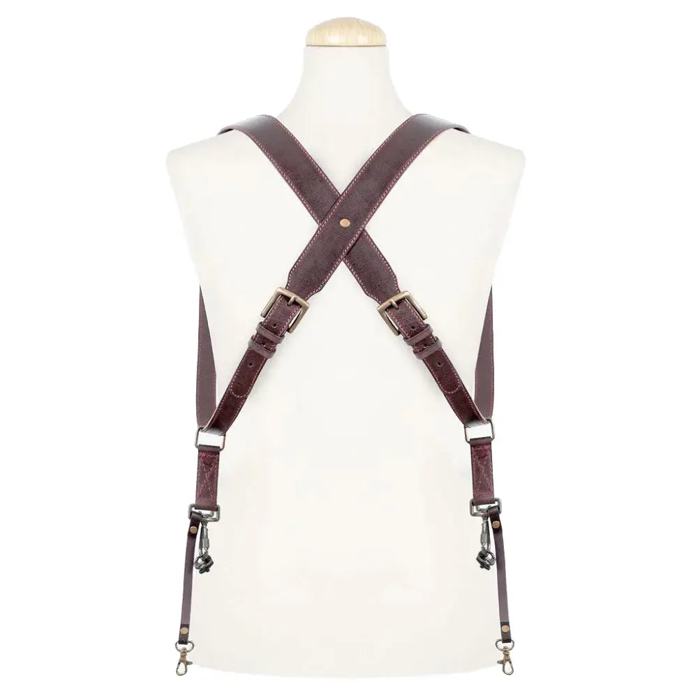 Brown leather suspenders on a mannequin against a white background