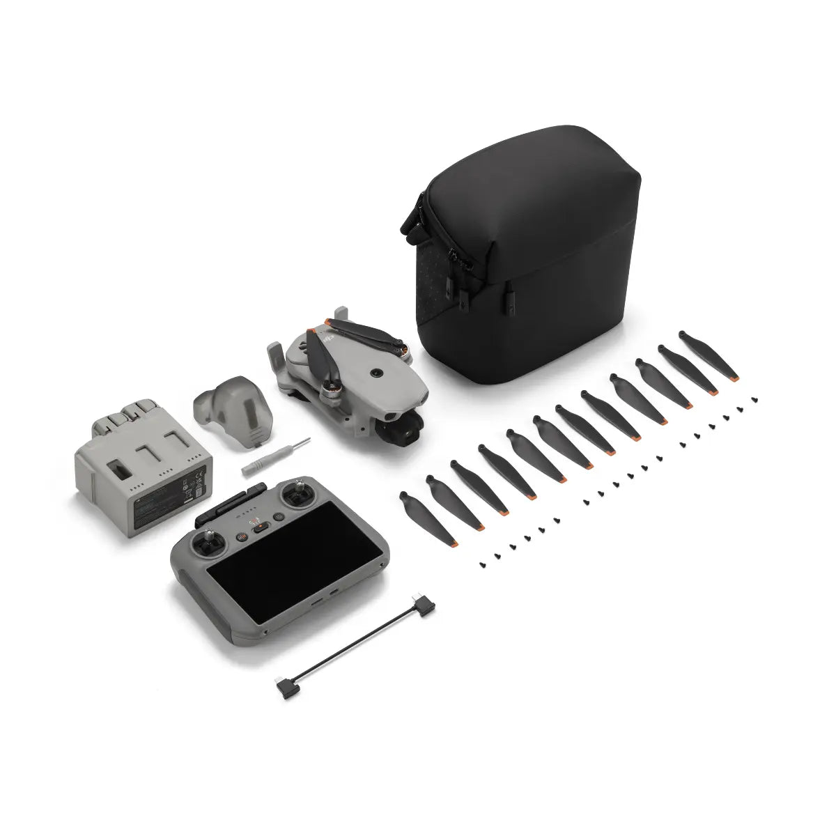 DJI Mavic Mini drone kit with remote control, propellers, and carrying case on a white background