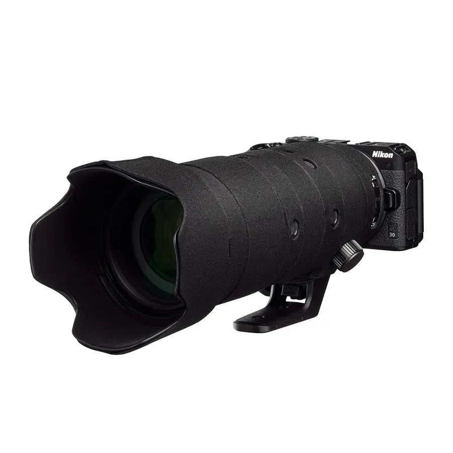 Black Nikon camera lens on a white background