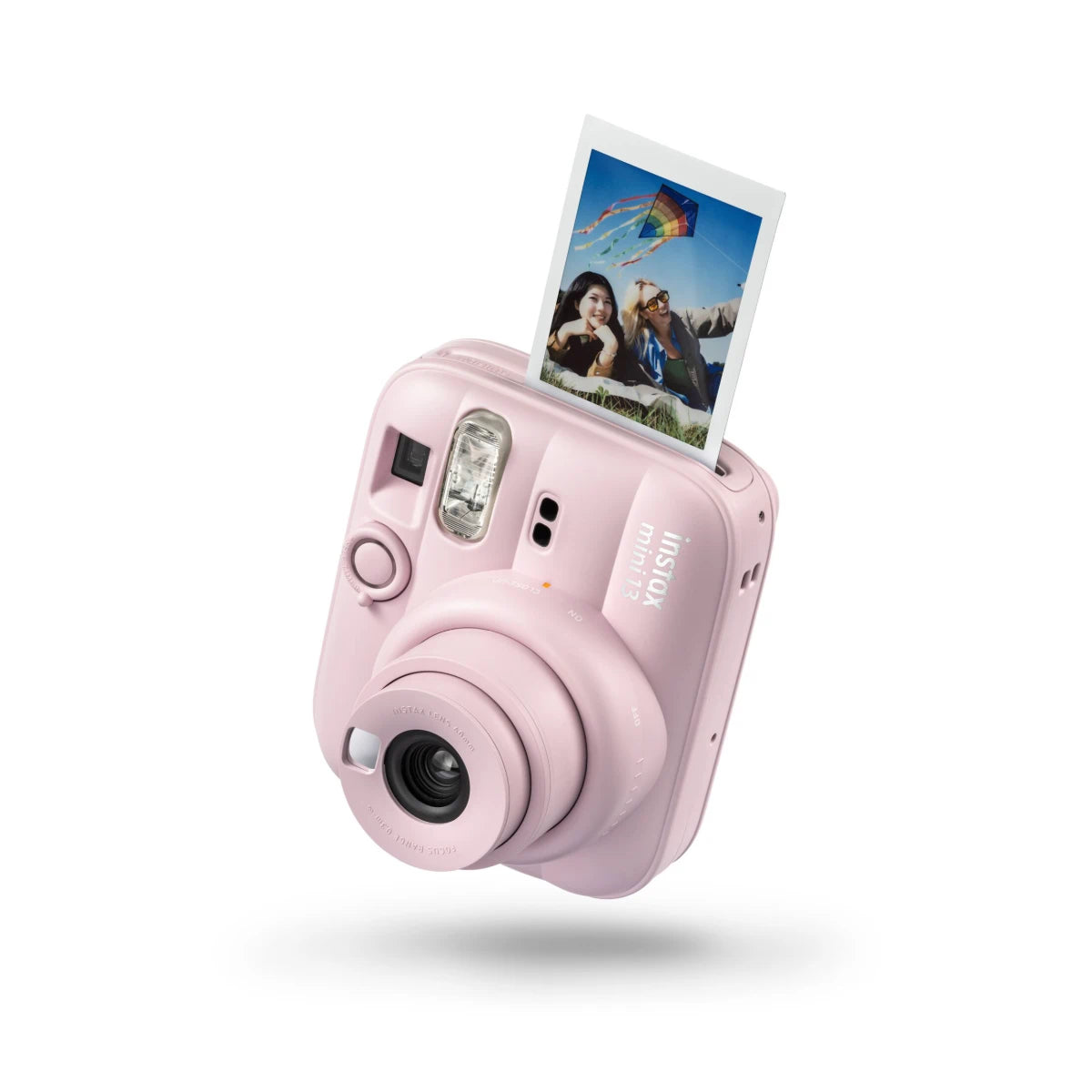 Pink instant camera with a photo on a white background