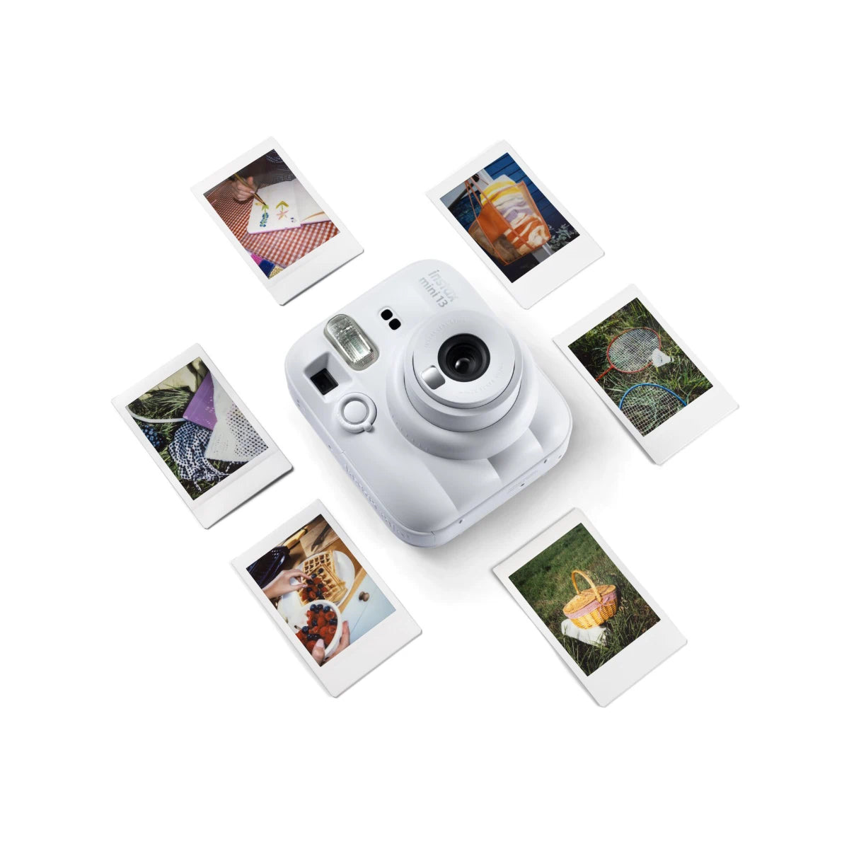 White instant camera with instant photos on a white background