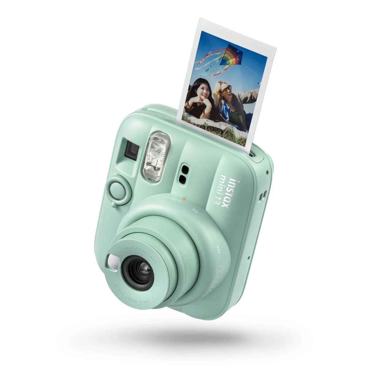Mint green instant camera with a photo on a white background