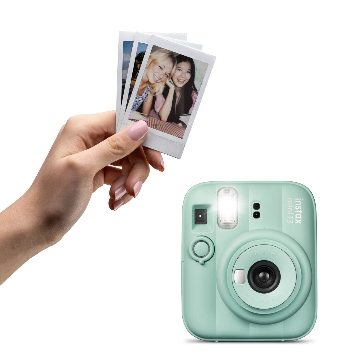 Mint green instant camera with a hand holding photos on a white background