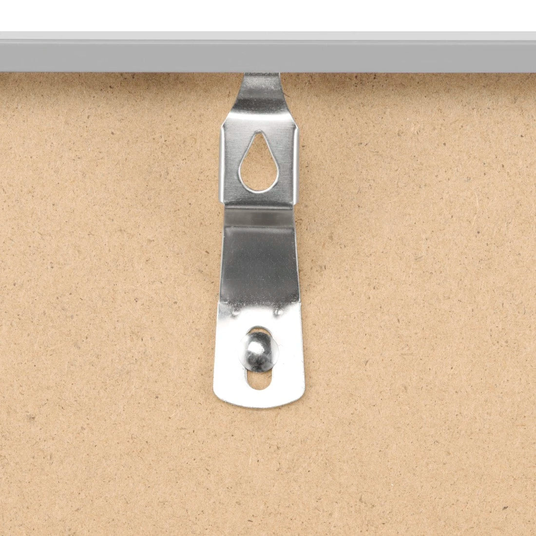 Metal picture hanger on a cardboard background