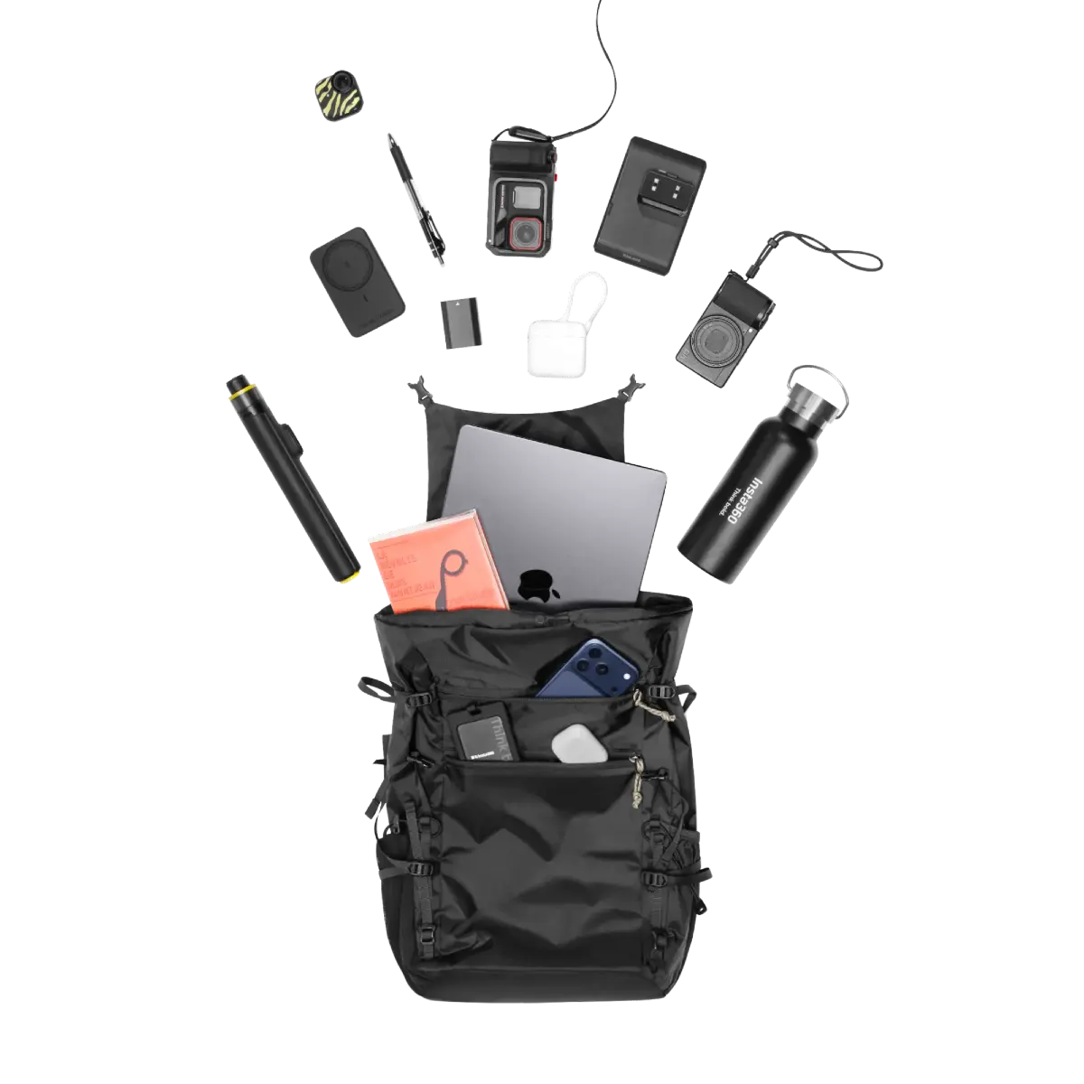 Black backpack with various items spilling out on a white background