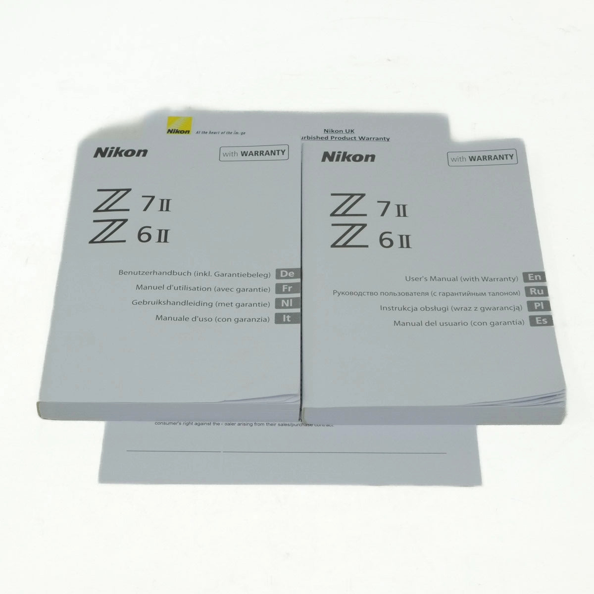 Nikon camera manual and warranty card on a white background