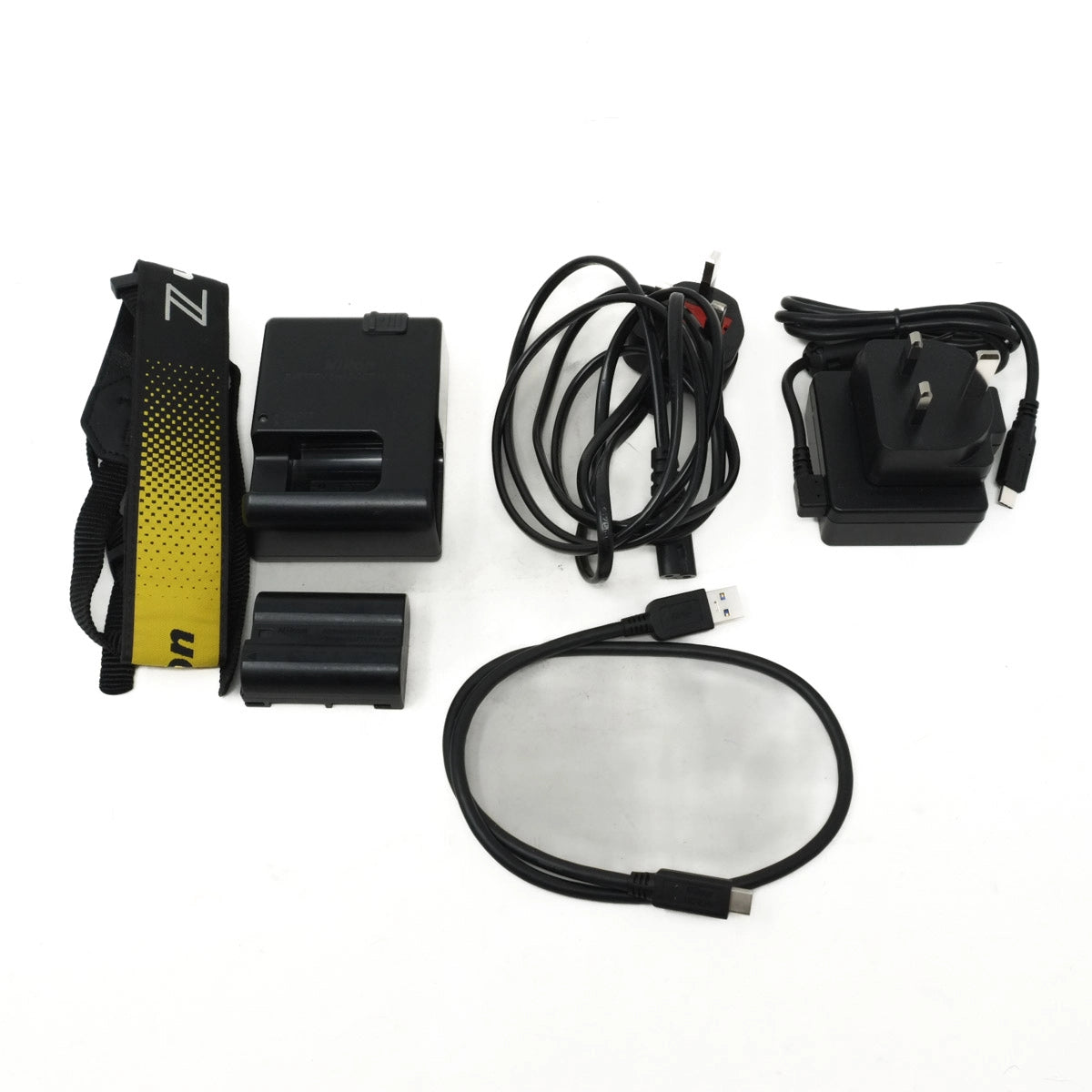 Collection of electronic components including a black battery pack, yellow and black strap on a white background.