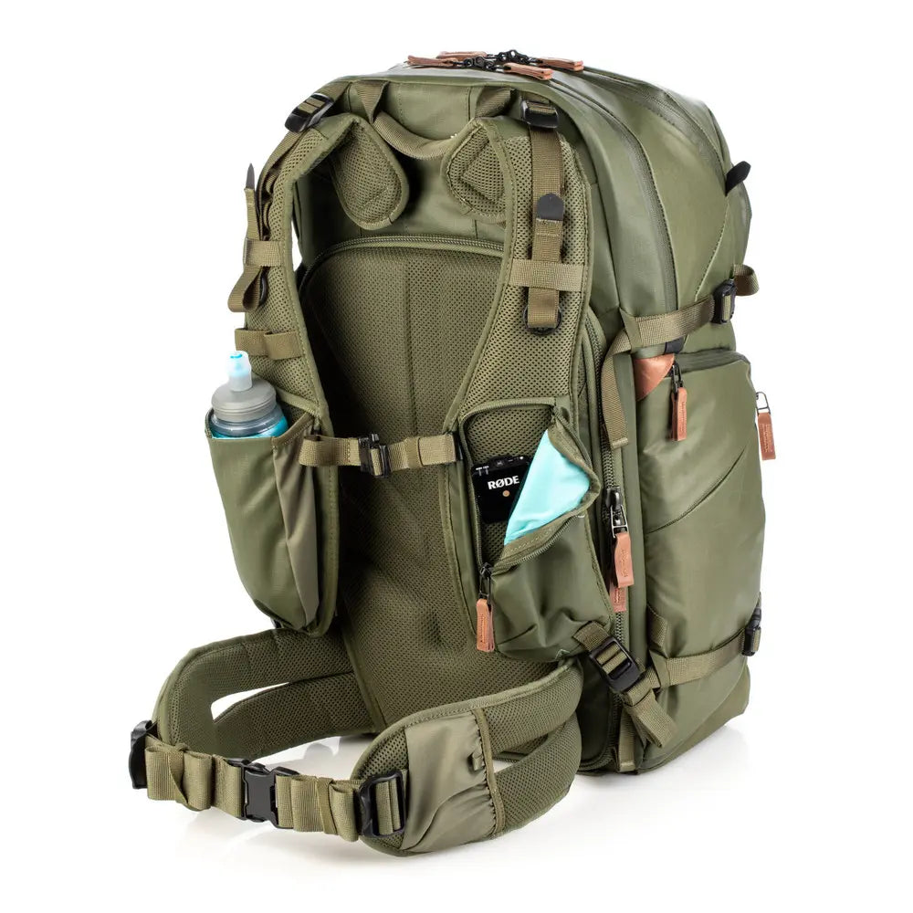 Green backpack with multiple compartments on a white background