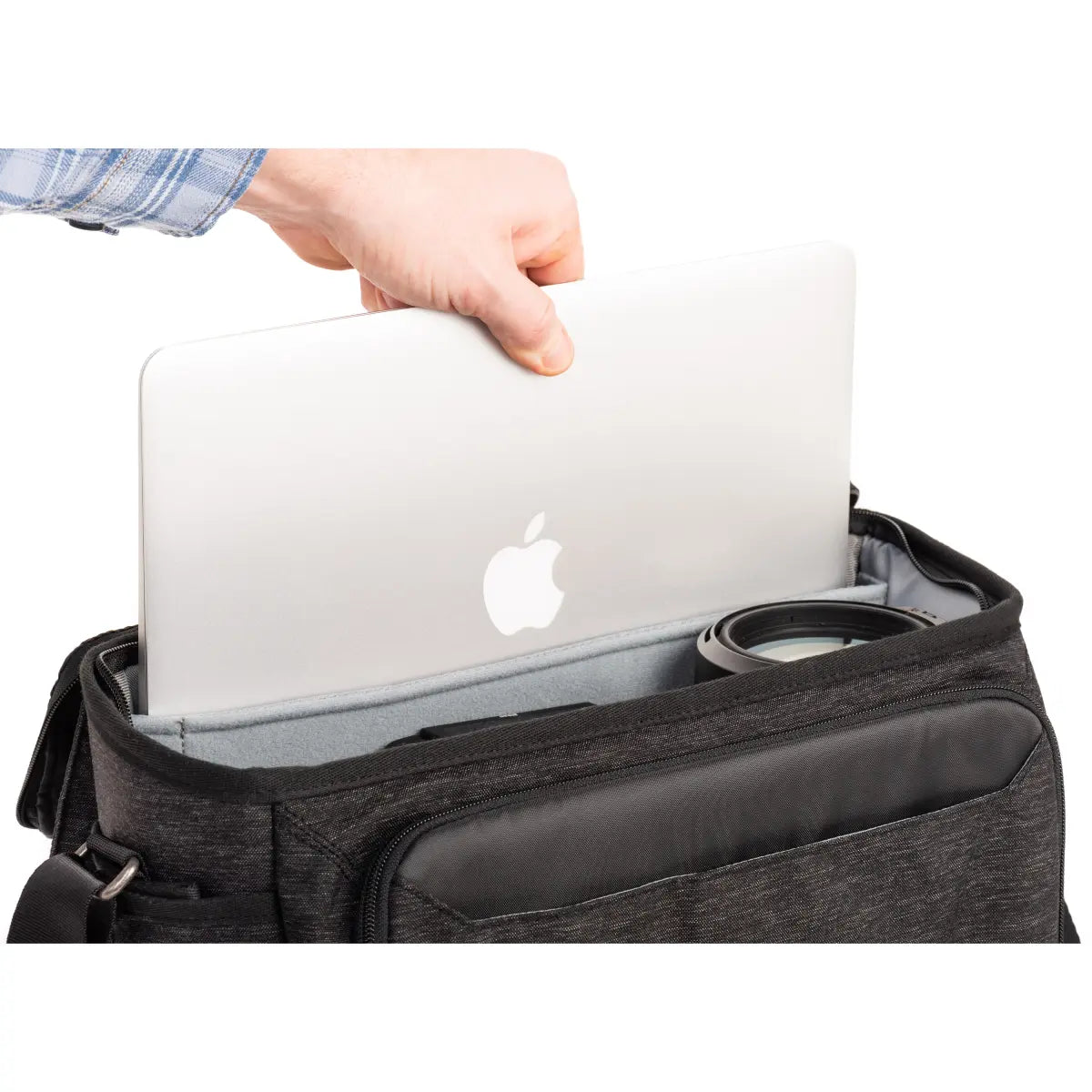 Person placing a laptop into a black bag with an Apple logo