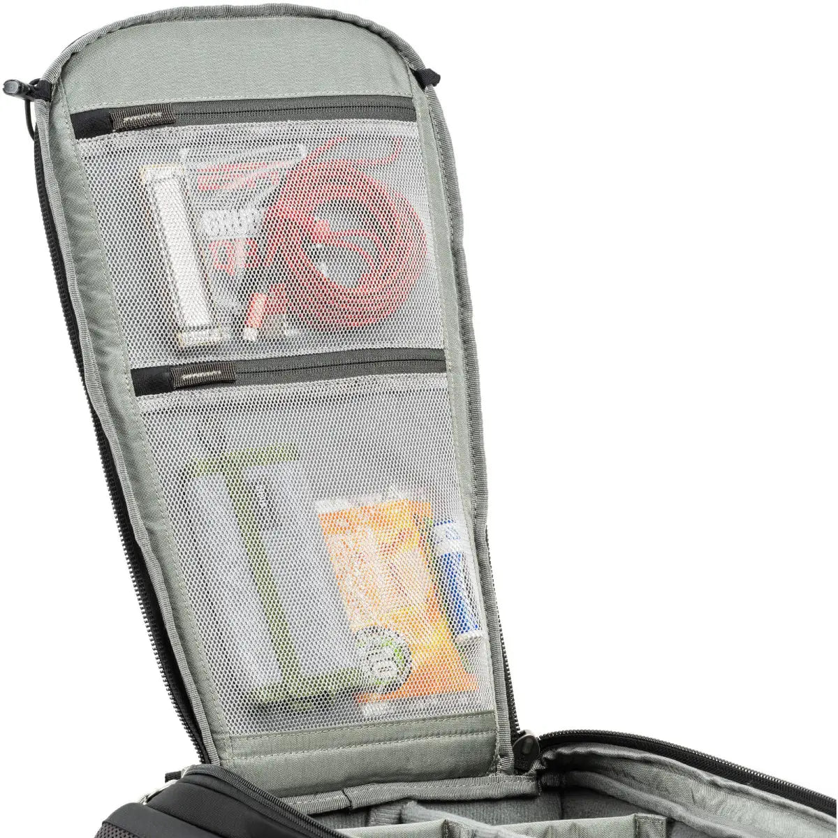 Gray travel organizer with mesh pockets containing toiletries on a white background