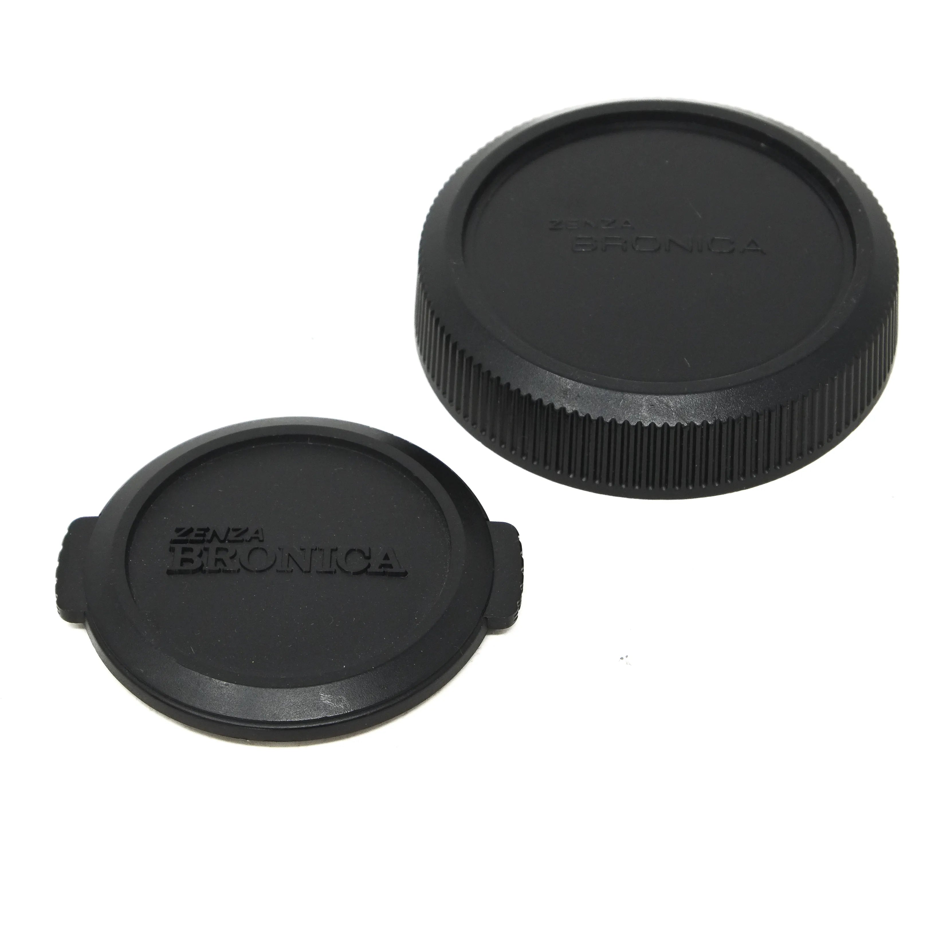 Two black camera lens caps with Bronica branding on a white background