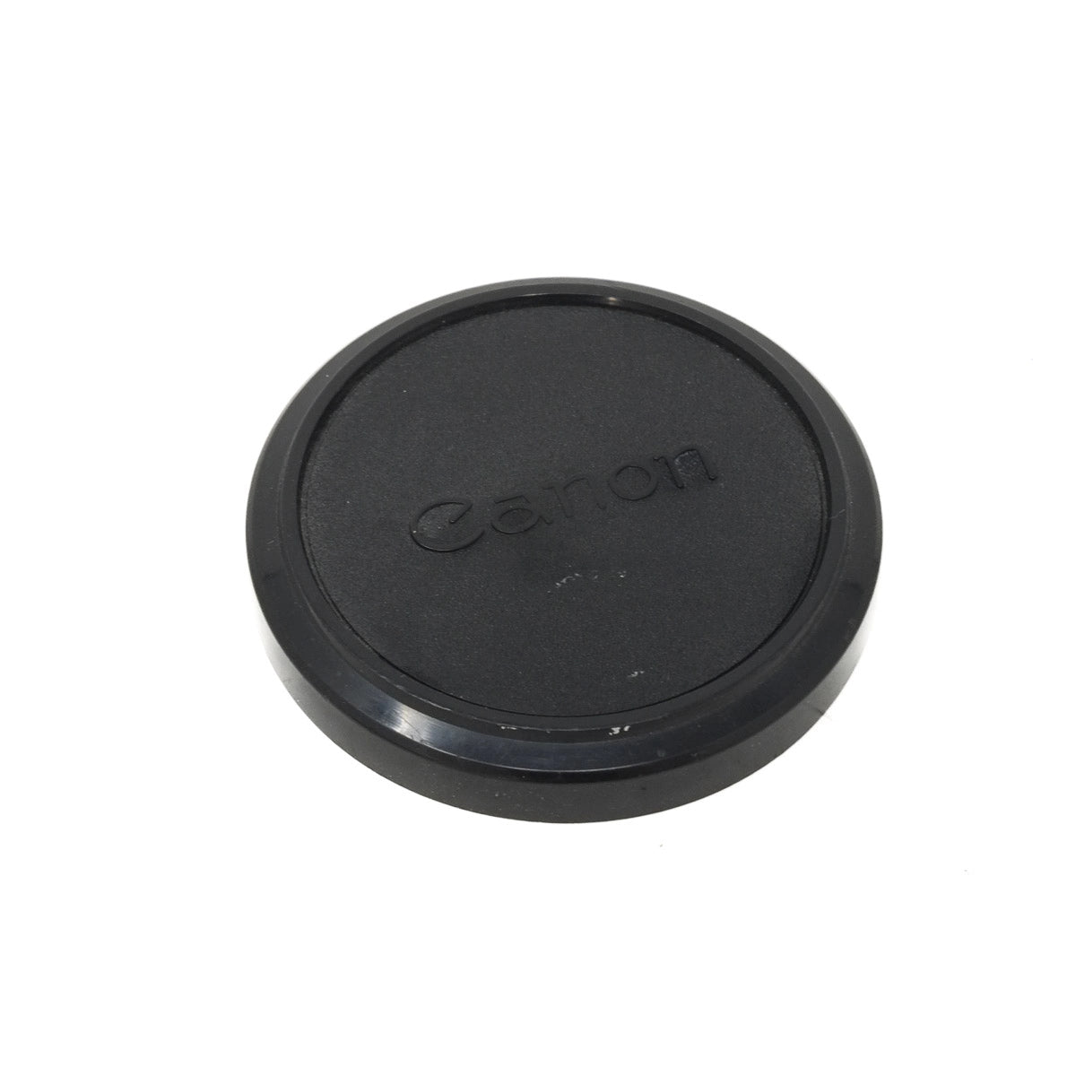 Black Canon lens cap on a white background