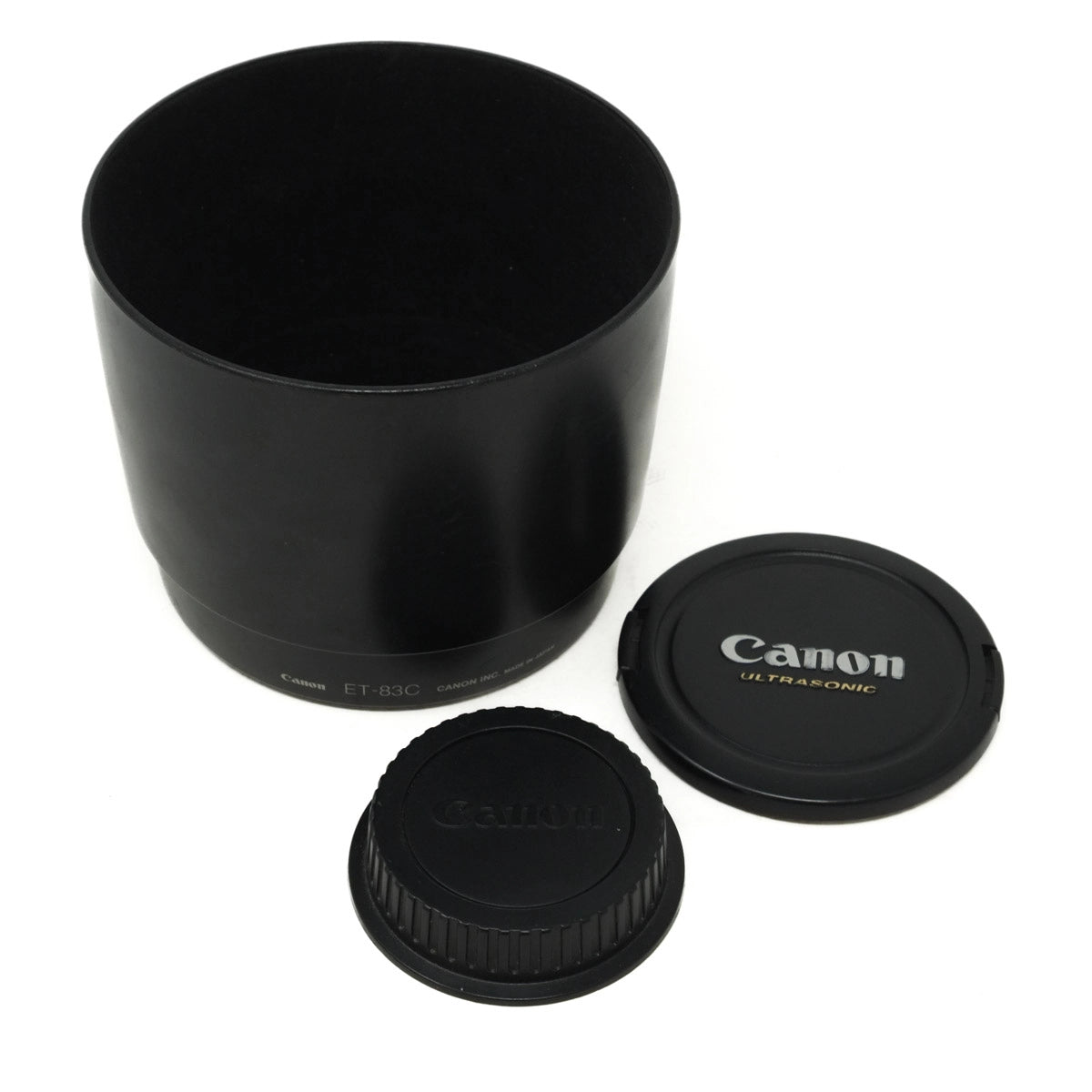 Canon lens hood and caps on a white background