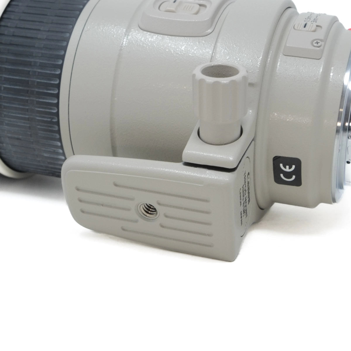 Close-up of a camera lens and part of the body on a white background