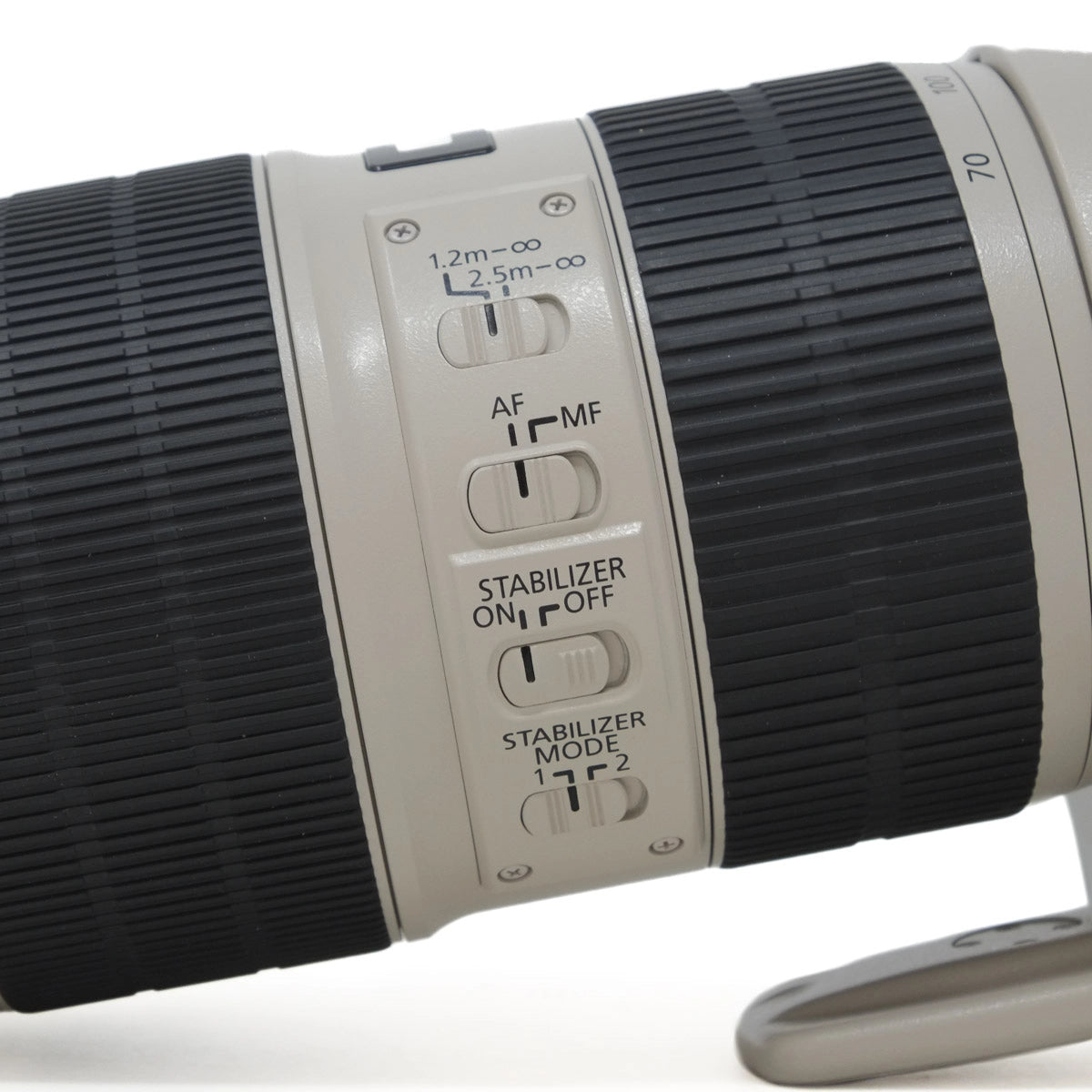 Close-up of a camera lens with control buttons on a white background