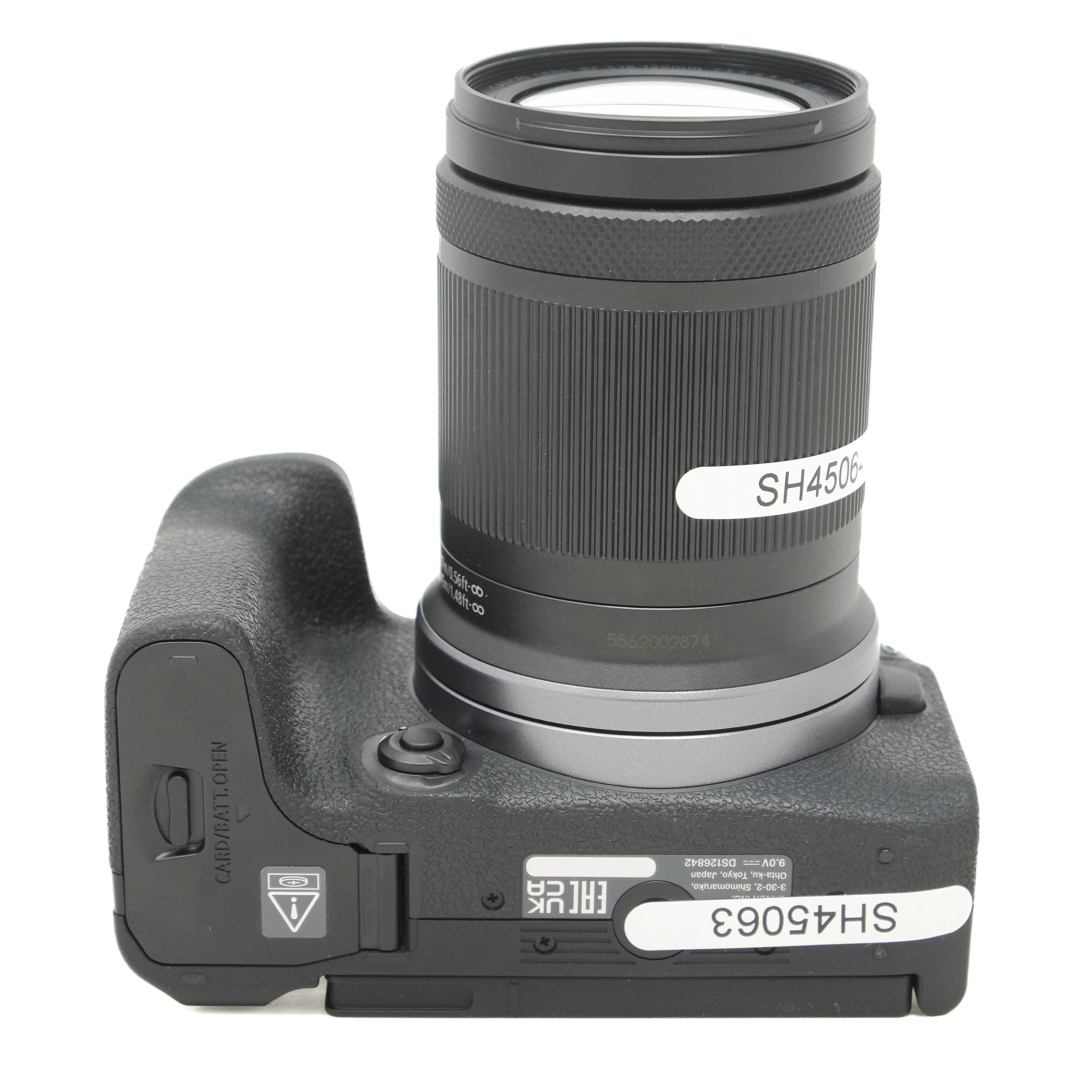 Camera body with lens on a white background