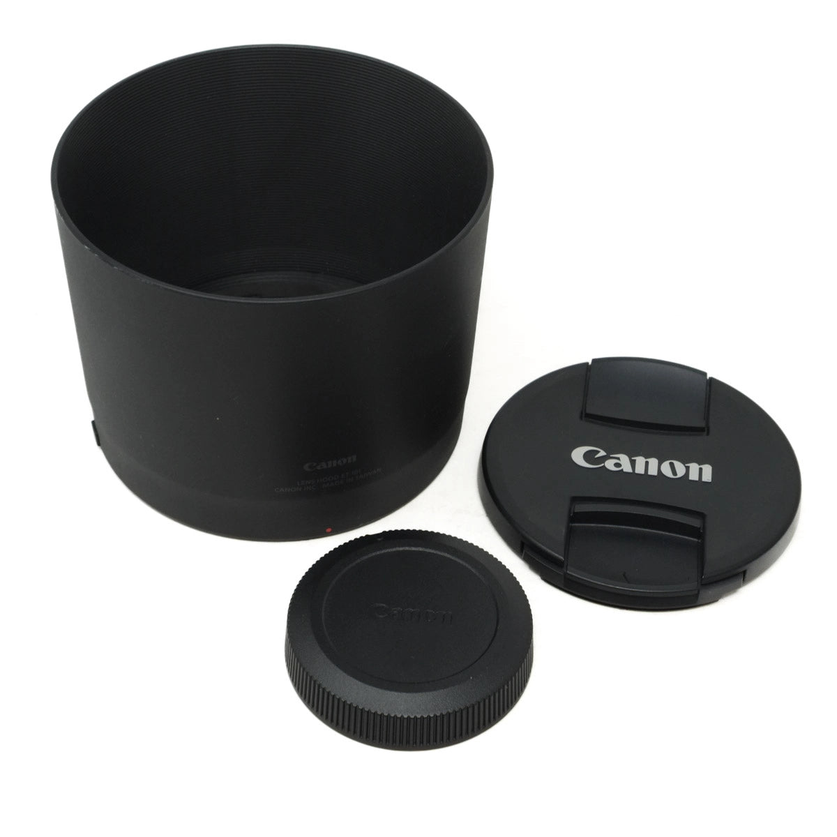 Canon lens hood and caps on a white background