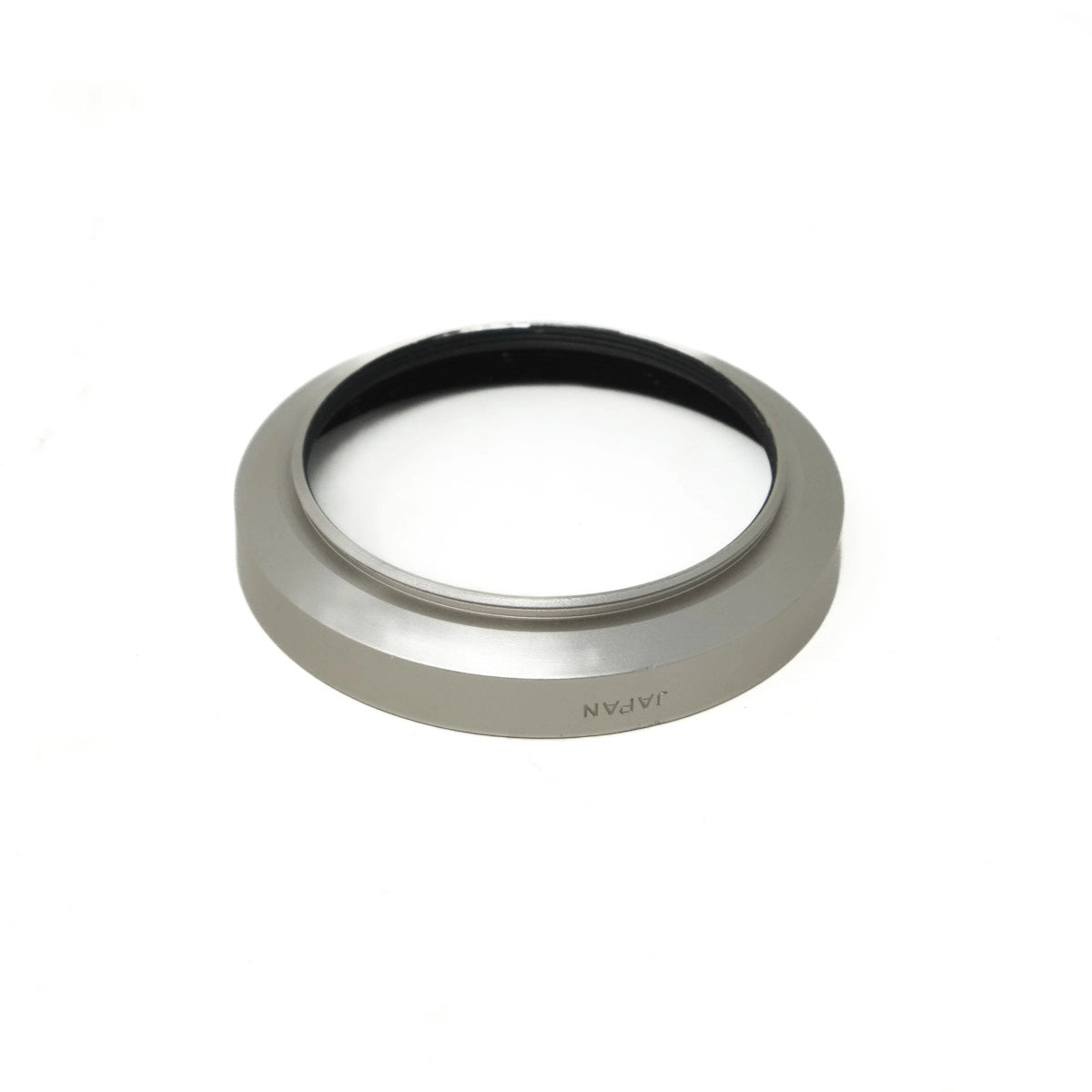 Metallic lens hood with 'Japan' text on a white background
