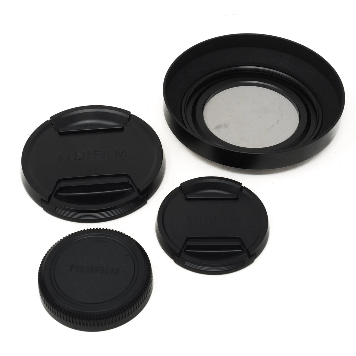 Set of black camera lens caps and hood on a white background