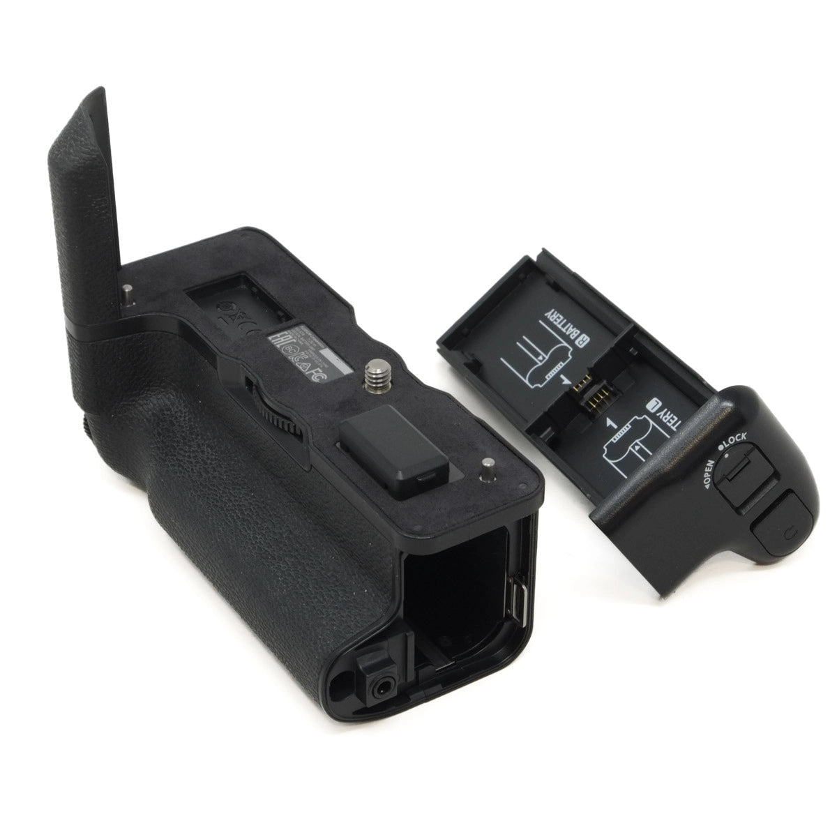Black camera battery grip and tray on a white background