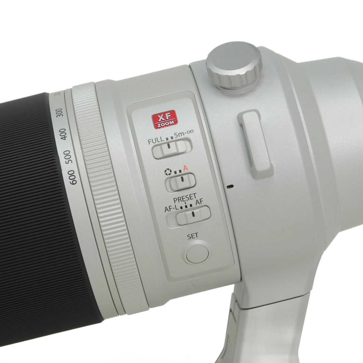 Close-up of a camera lens with control buttons on a white background