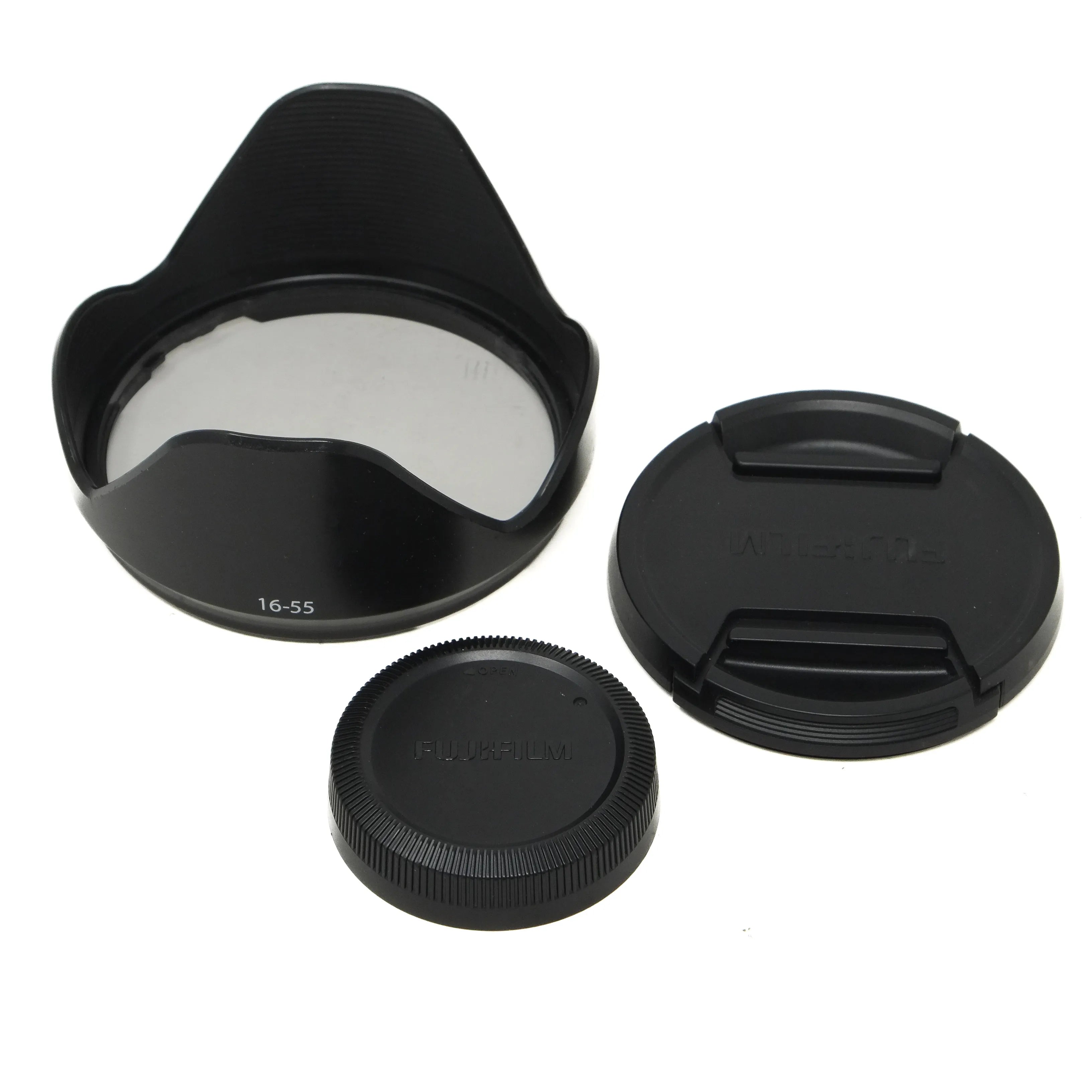 Camera lens accessories including a lens hood, front and rear caps on a white background