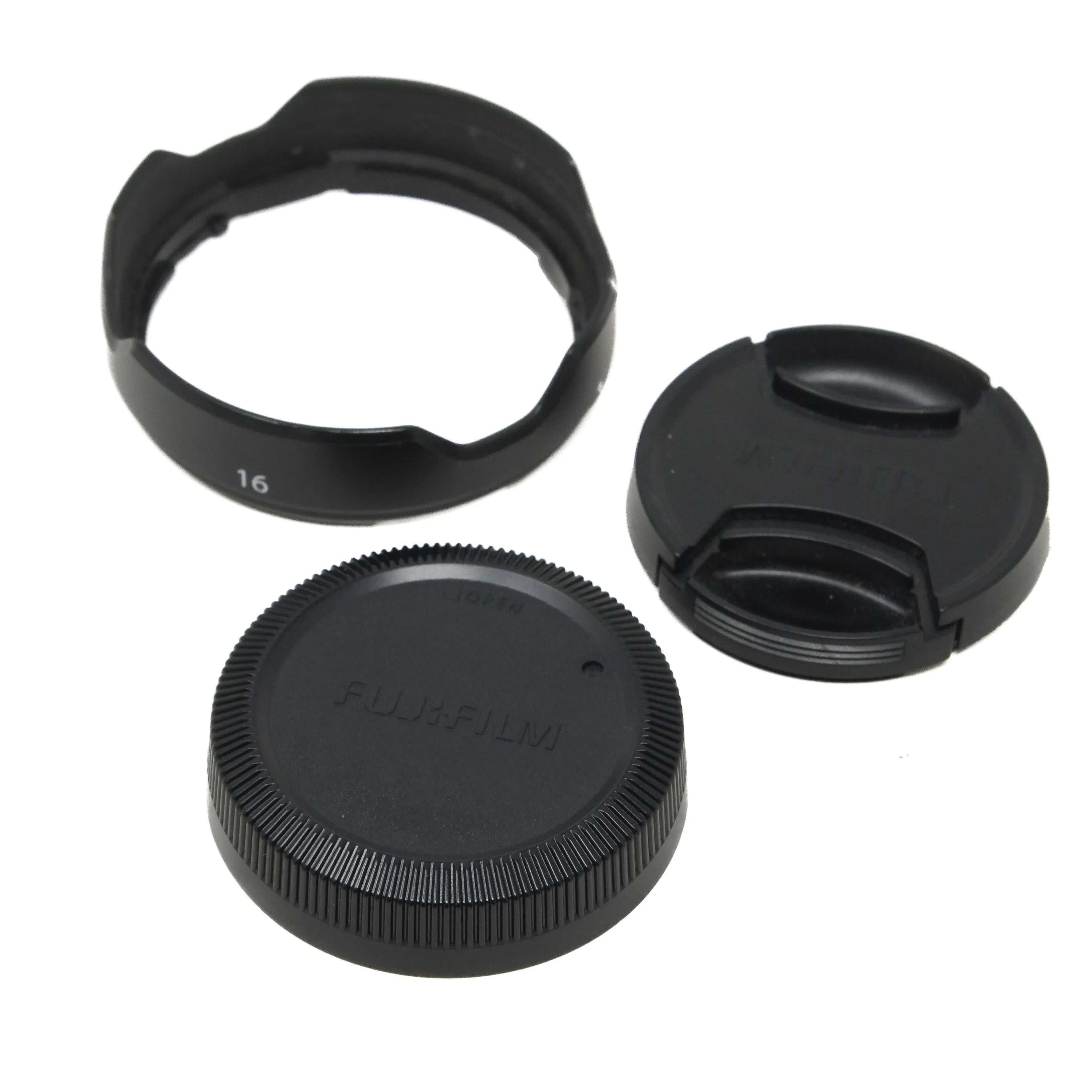 Camera lens accessories including a lens hood, front and rear lens caps on a white background