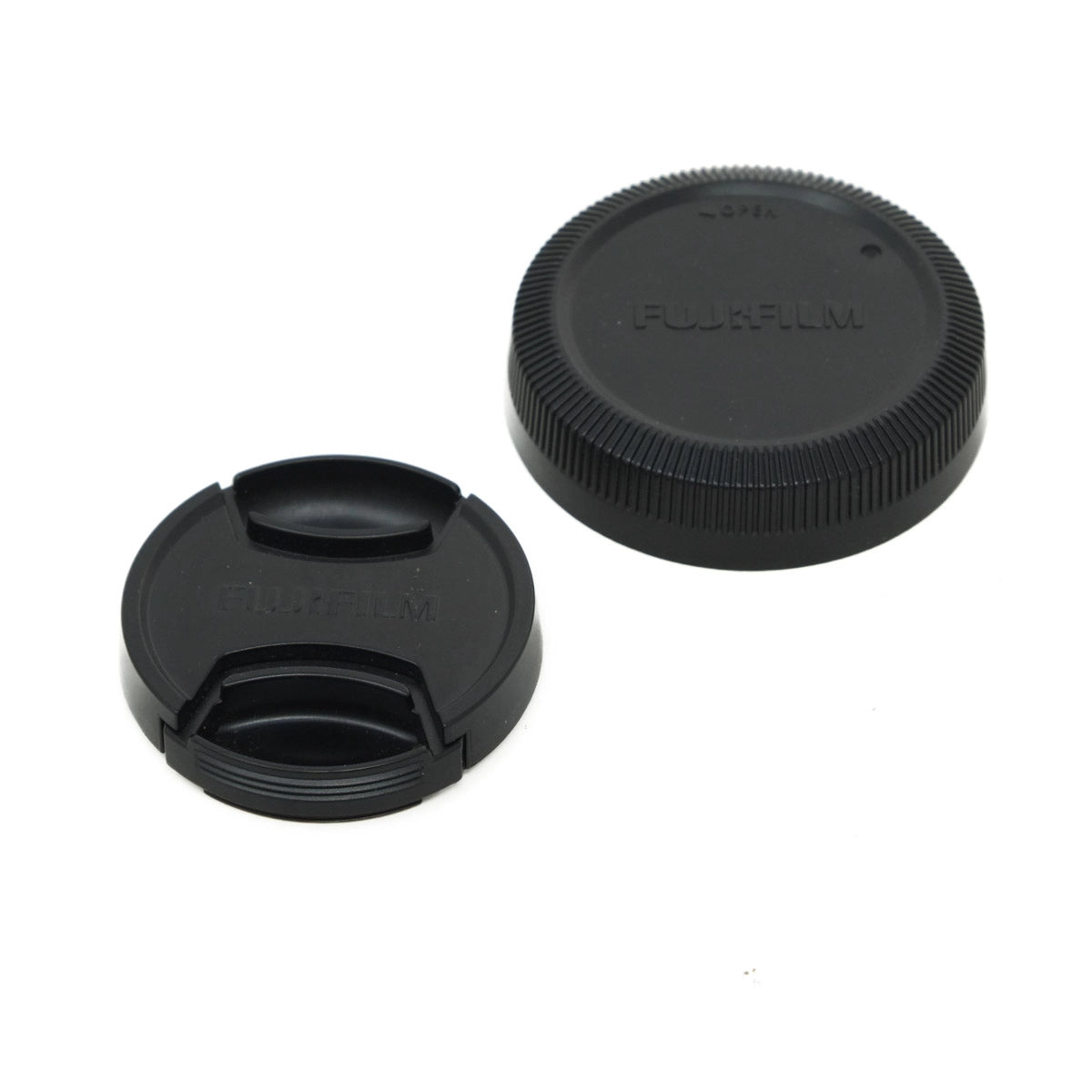 Two black camera lens caps with Fujifilm branding on a white background