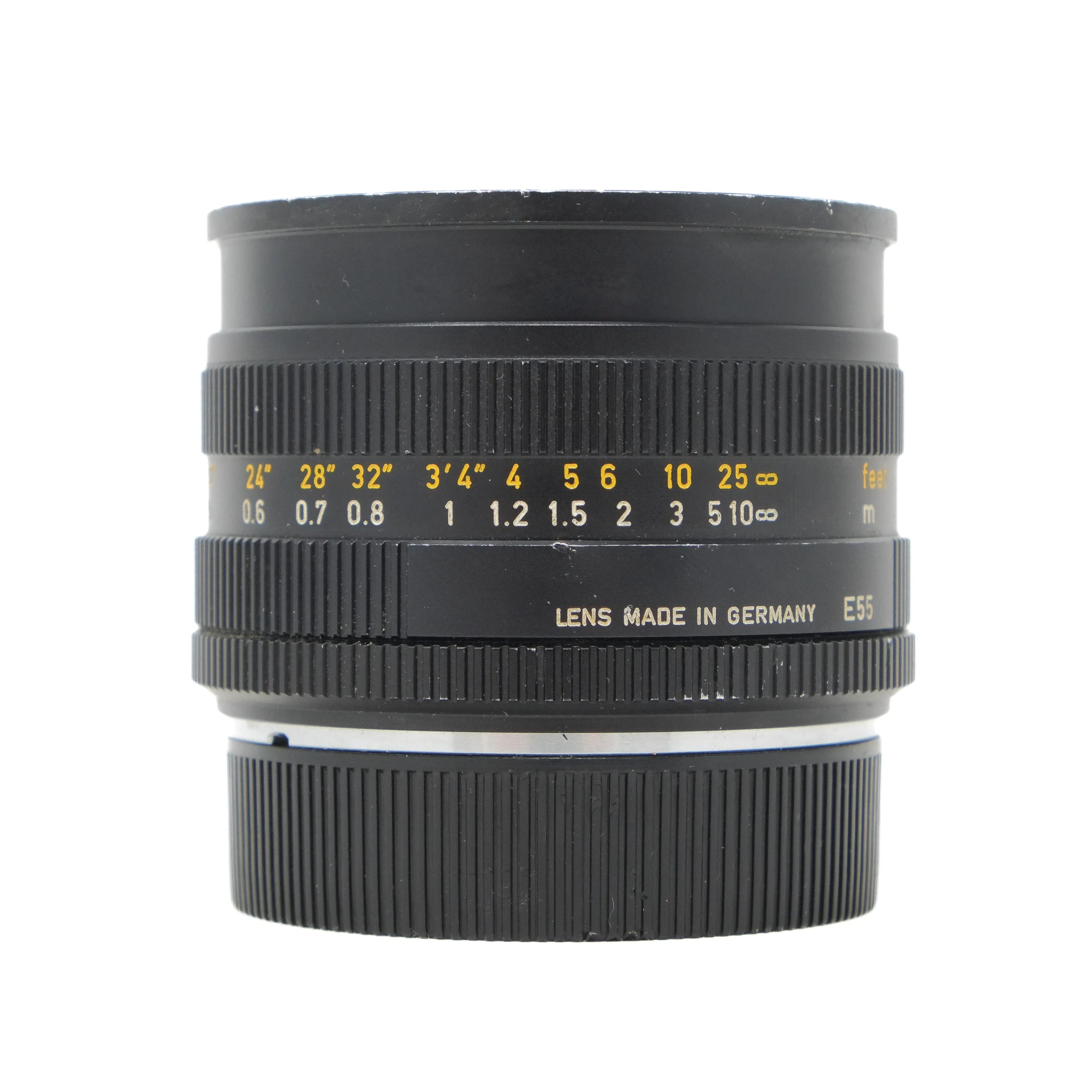 Camera lens with focus scale and 'Made in Germany' text on a white background