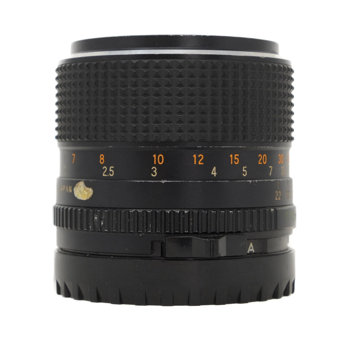 Black camera lens with focus scale on a white background
