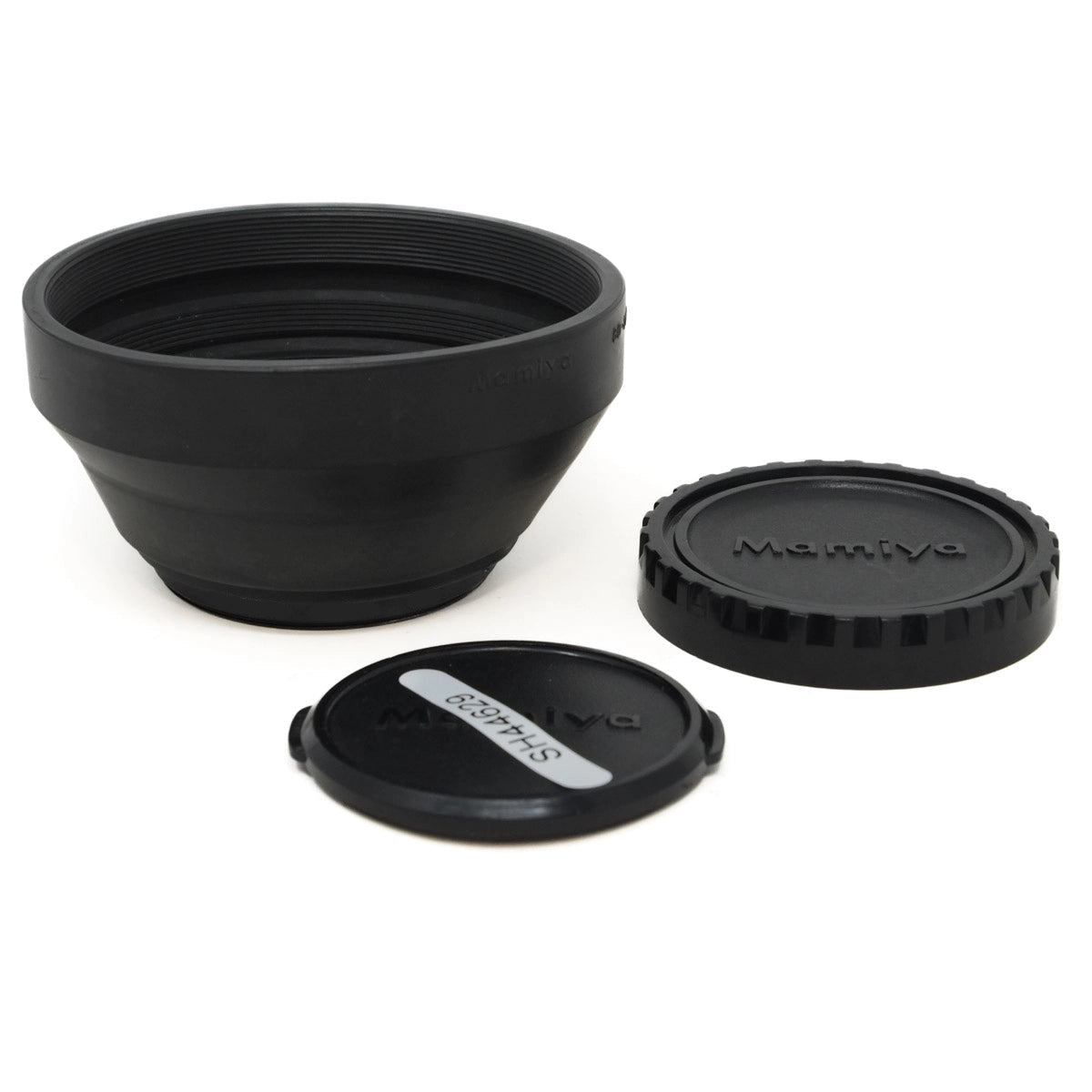 Black camera lens hood and caps on a white background
