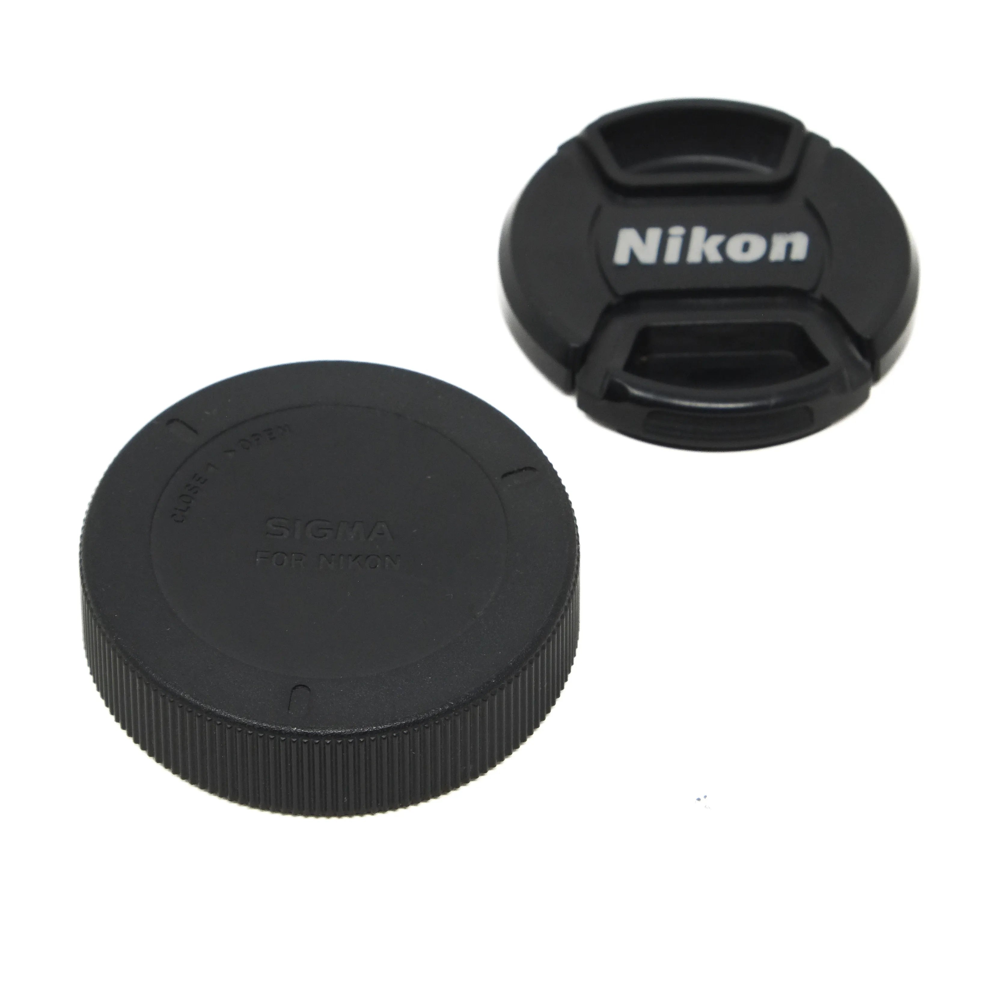 Black camera lens cap with Nikon logo on a white background