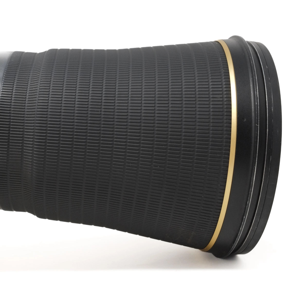 Close-up of a black camera lens on a white background