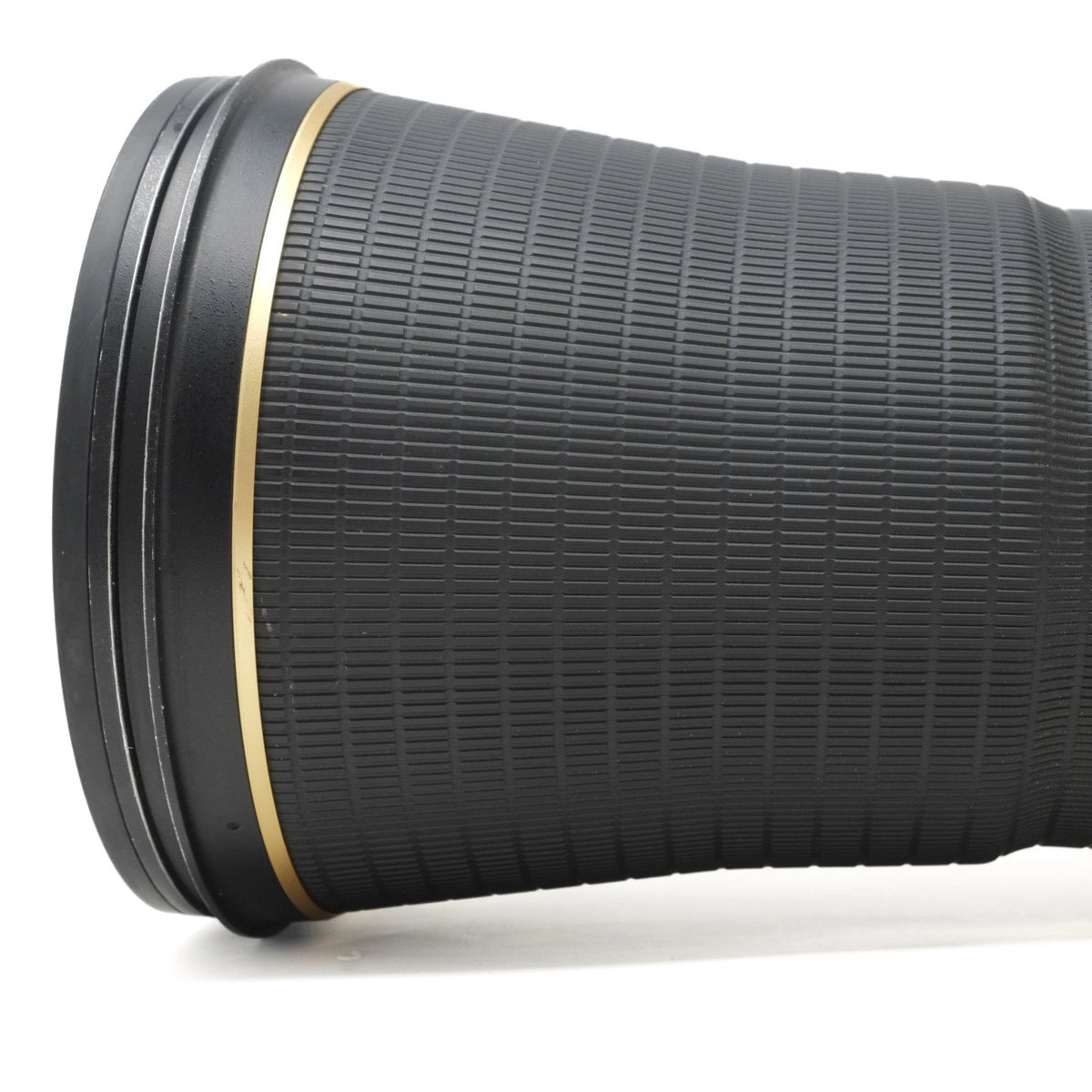Close-up of a black camera lens on a white background