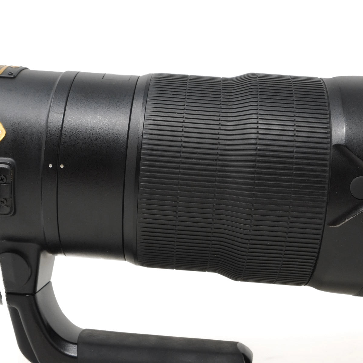 Close-up of a black camera lens on a white background