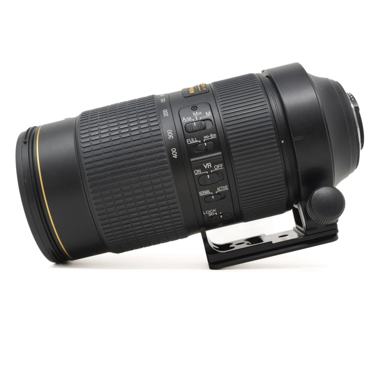 Camera lens with focus ring and control buttons on a white background