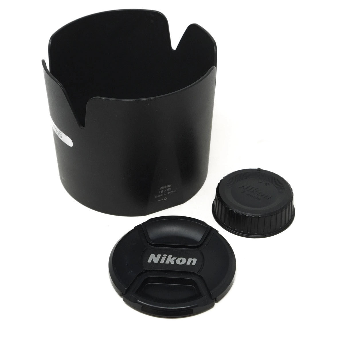 Black camera lens hood and cap with Nikon logo on a white background