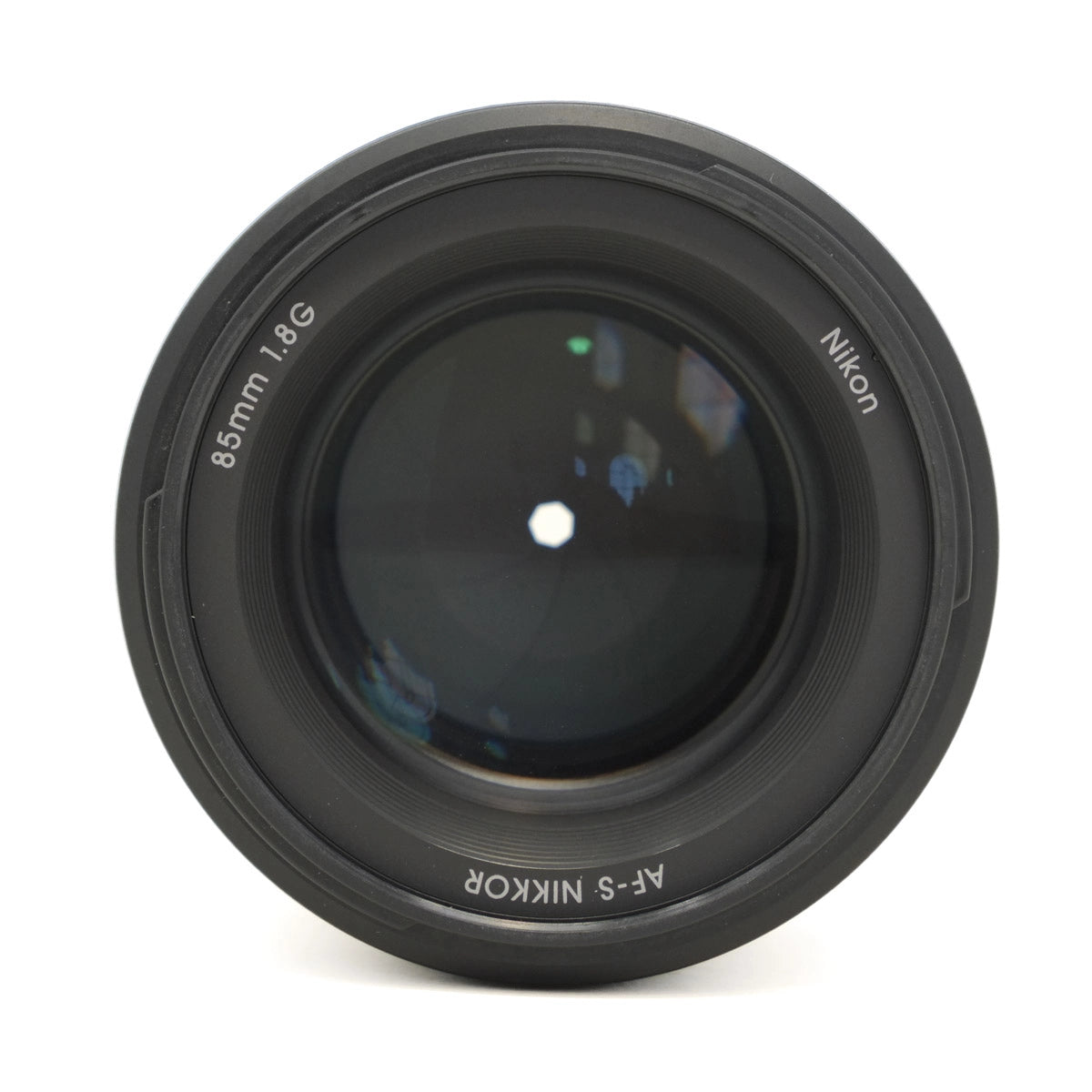Nikon camera lens with '85mm f/1.8G' on a white background