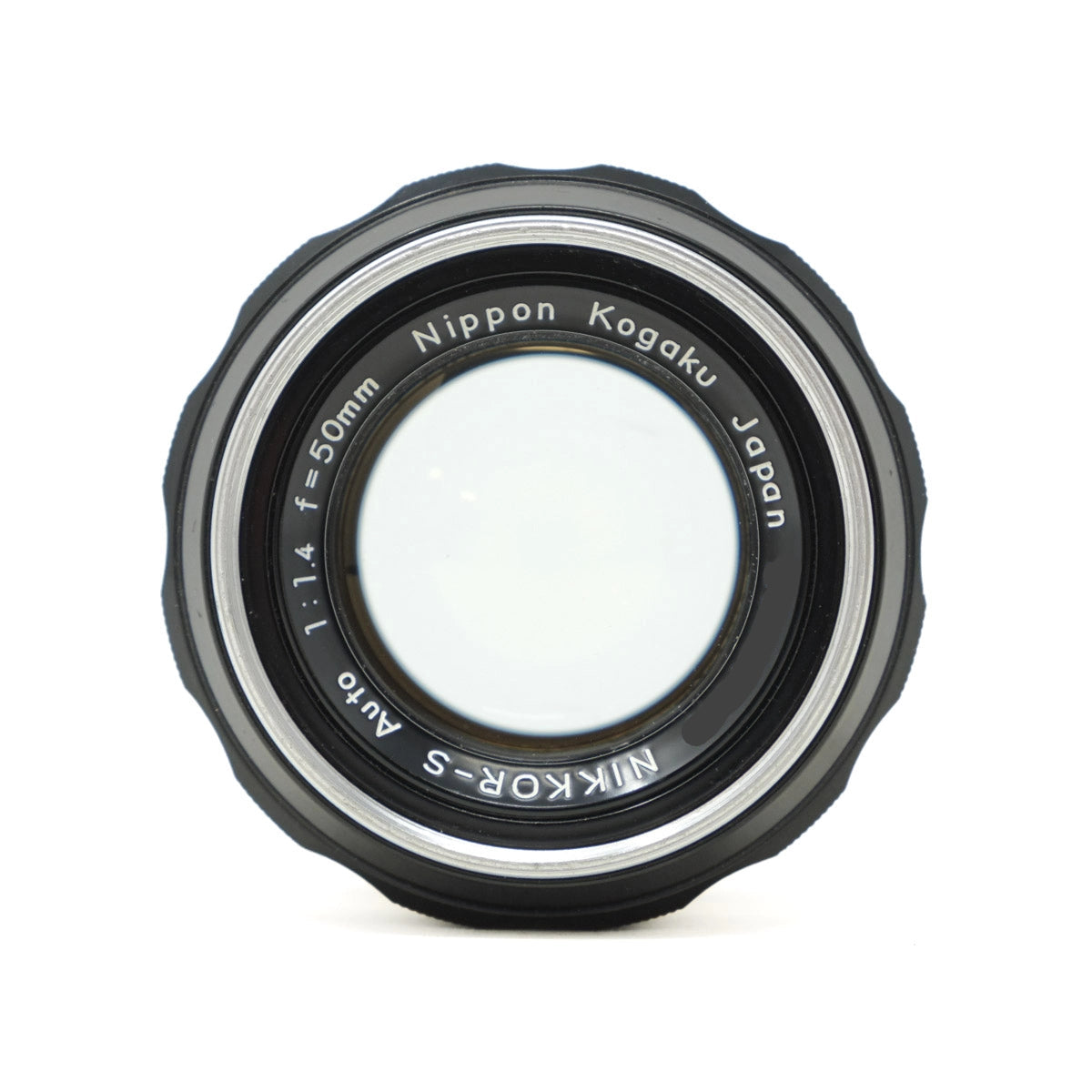 Camera lens with 'Nippon Kogaku' branding on a white background