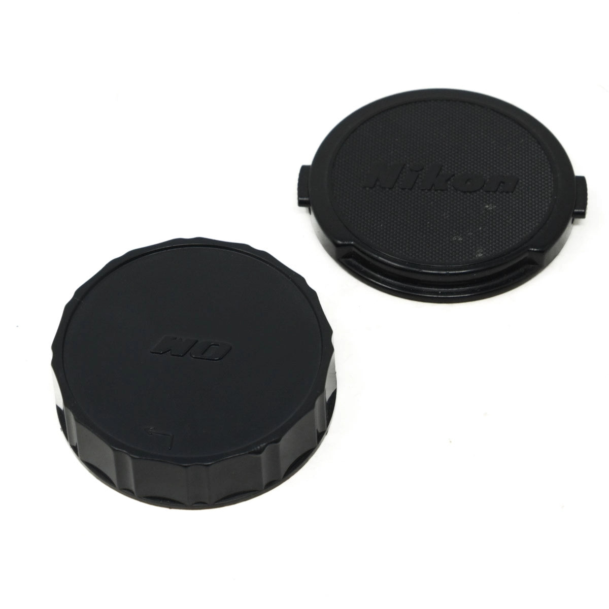 Two black camera lens caps with 'Nikon' branding on a white background
