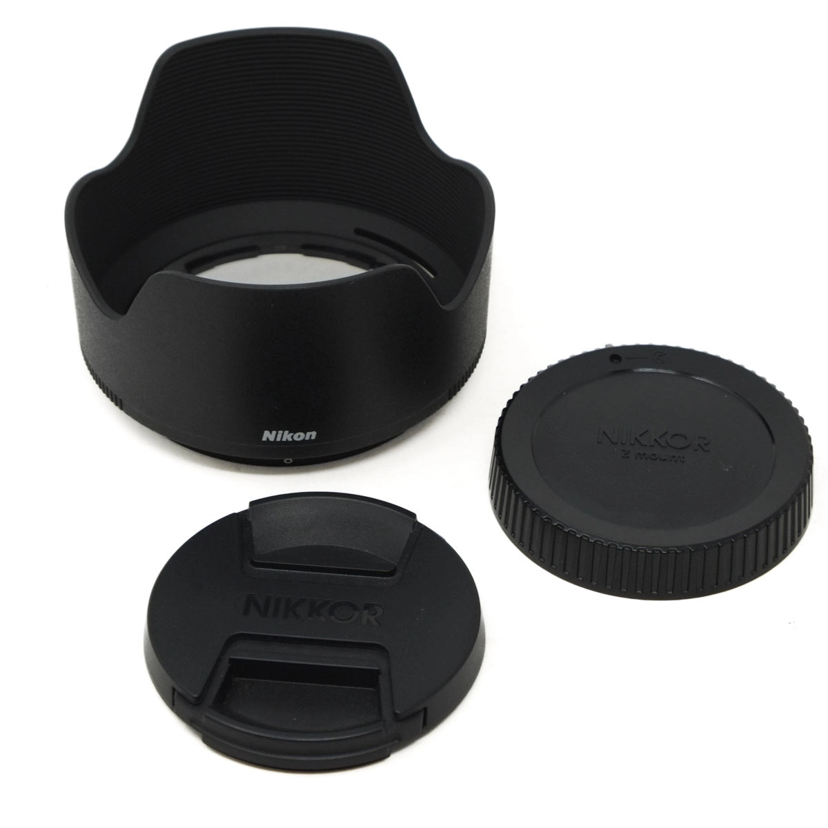 Nikon lens hood and caps on a white background