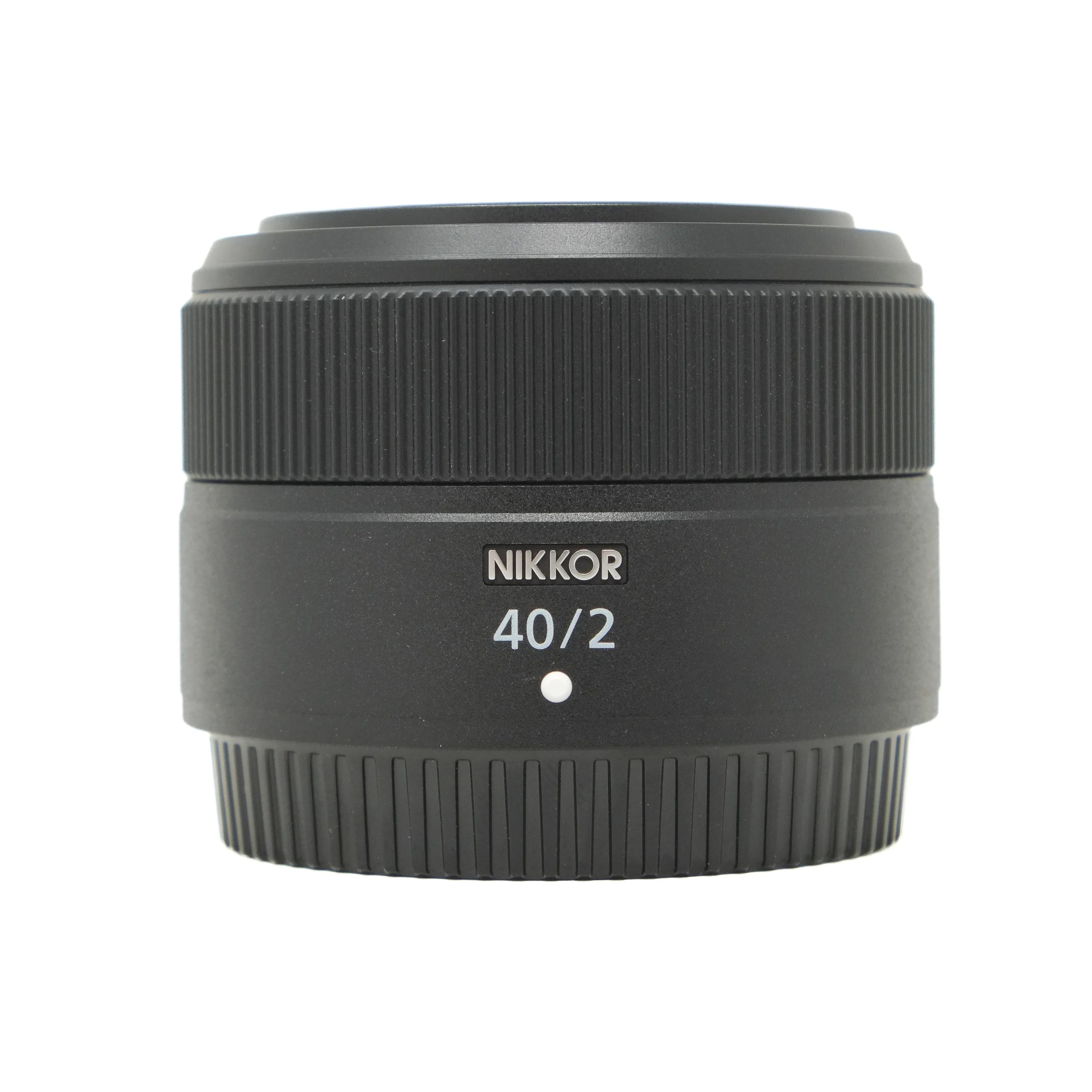 Black Nikkor camera lens on a white background