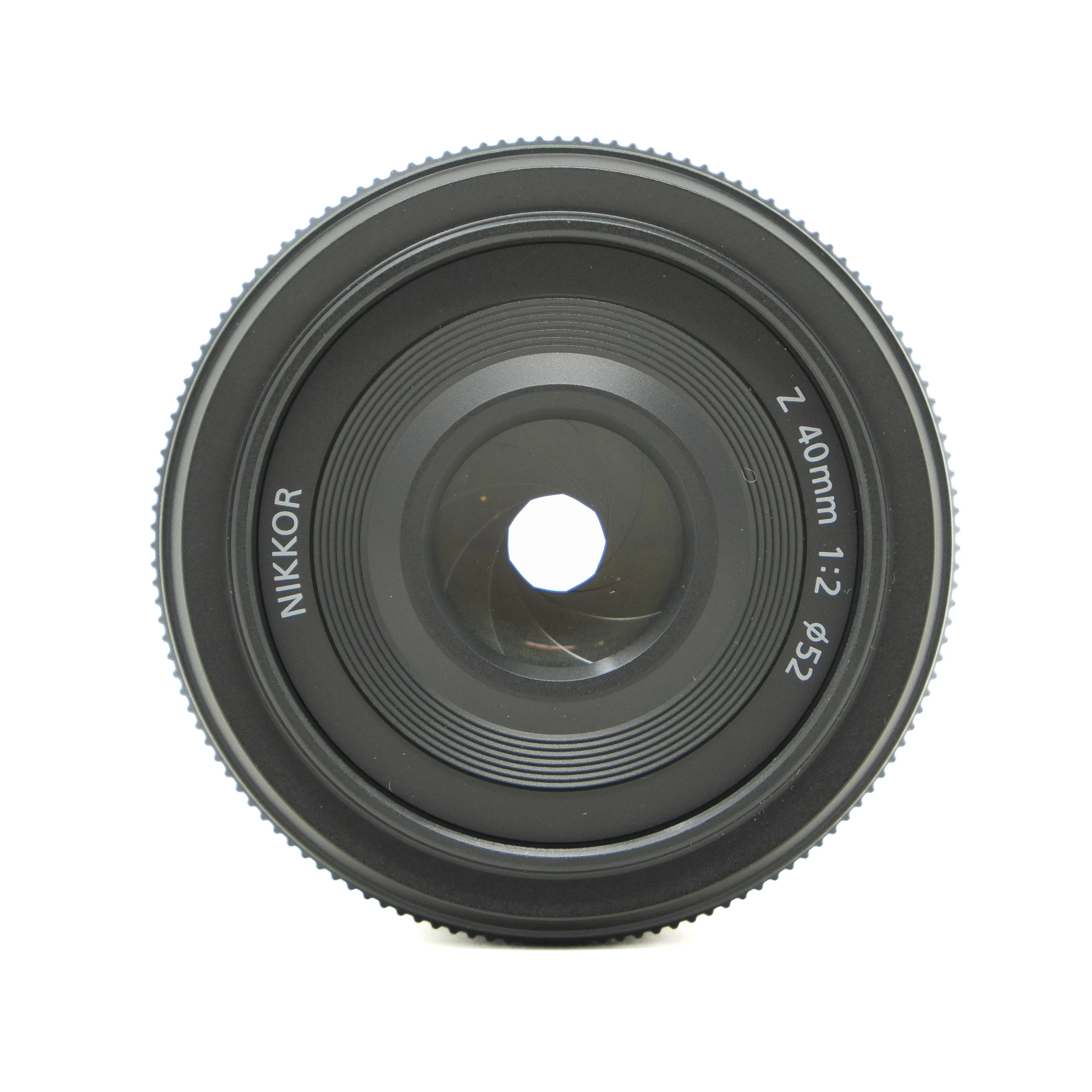 Camera lens with 'Nikkor' branding on a white background